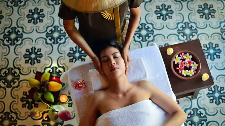 Spa massage setup with flower petals and patterned tiles in Bali