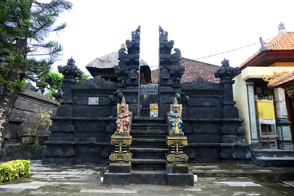 Tanah Lot temple entrance with traditional Balinese stone gate and guardian statues