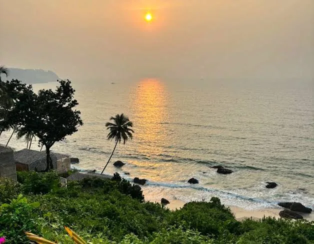 Cabo de Rama in South Goa with a sunset sea view, palms and a cliffside shoreline