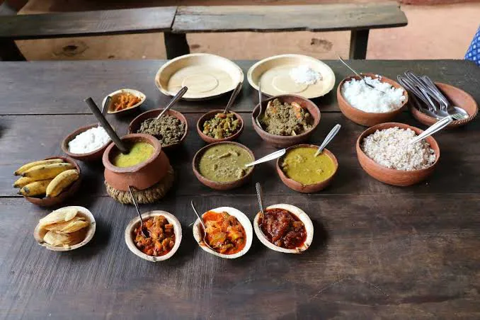 Spice plantation lunch in Goa with regional dishes arranged on a wooden table