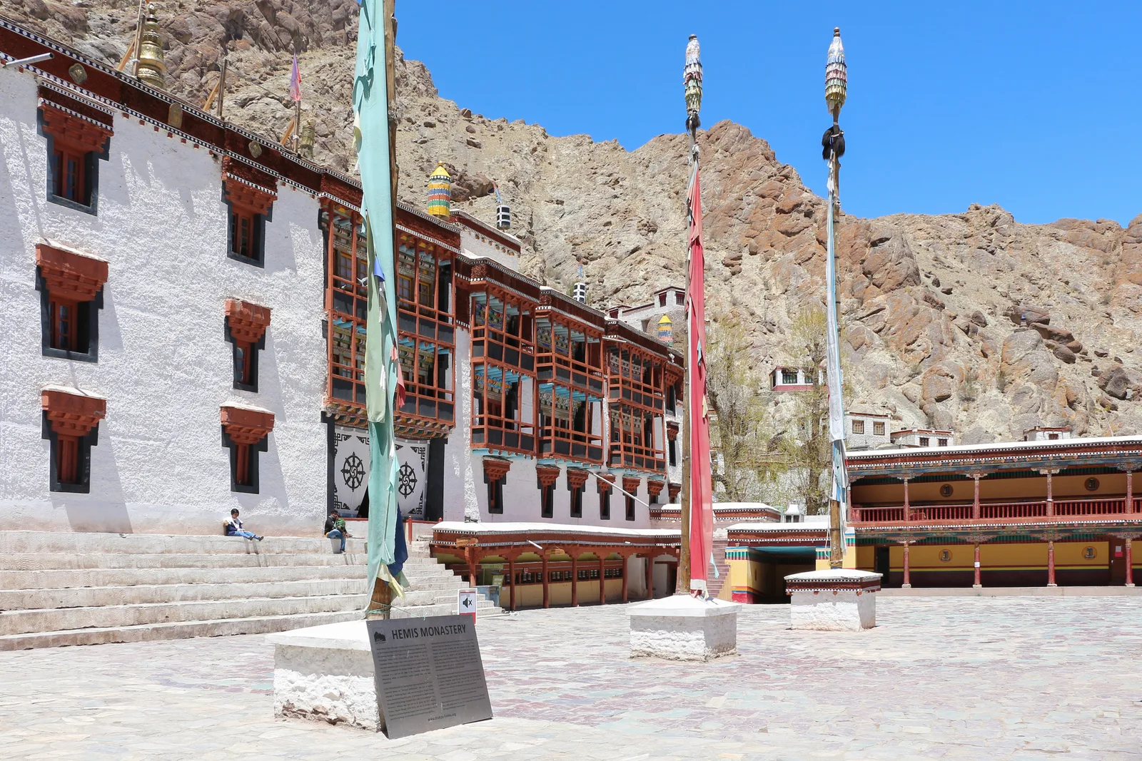 The white courtyard and painted balconies of Hemis Monastery